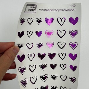 May include: A sheet of purple and black heart stickers with a variety of designs. The sheet is labeled "Sticky Impact" and "www.etsy.com/shop/stickyimpact". The price is listed as $100.