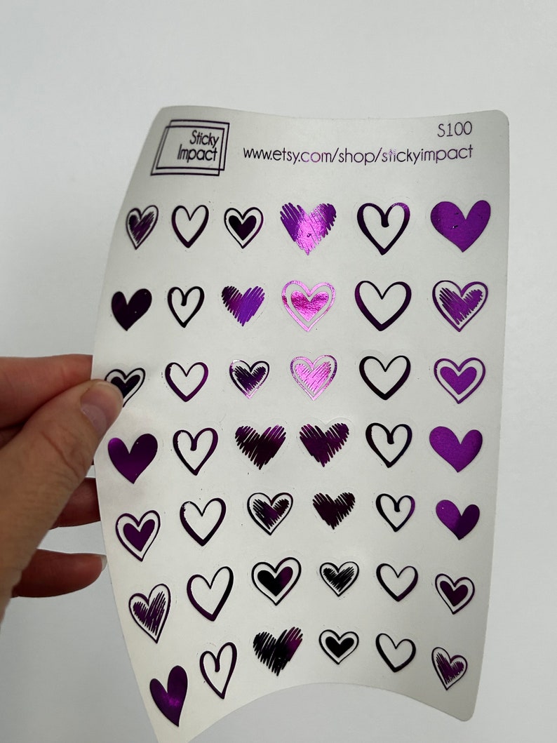 May include: A sheet of purple and black heart stickers with a variety of designs. The sheet is labeled "Sticky Impact" and "www.etsy.com/shop/stickyimpact". The price is listed as $100.
