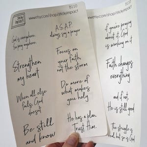 May include: Six inspirational quotes printed on white cards with black ink. The quotes are: "God is everywhere. So pray anywhere.", "Strengthen my heart", "When all else fails, God doesn't", "Be still and know", "A.S.A.P. always say a prayer", "Focus on your faith, not the storm", "Do more of what makes you holy", "He has a plan. Trust Him.", "If you're praying about it, God is working on it", "Faith changes everything", "And if not, He is still good", "The struggle is real, but so is God."