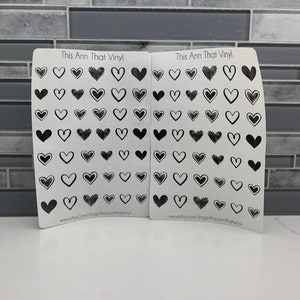 May include: Two sheets of white vinyl stickers with black heart designs. The sheets are labeled "This Ann That Vinyl" and include the website address "www.etsy.com/shop/thisannthatvinyl".