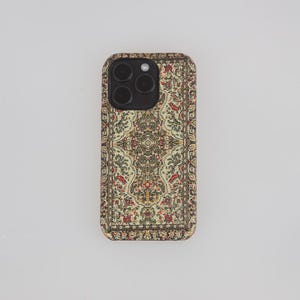 May include: A black phone case with a colourful patterned design that resembles a rug. The pattern is a mix of red, green, yellow, and blue.