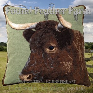 May include: A brown and white cow with horns, close-up portrait, tapestry cushion cover, green background, "Found Feather Farm" text, "Antiquities - Equine Fine Art" text, "Found Objects - The Eclectic and Rare" text