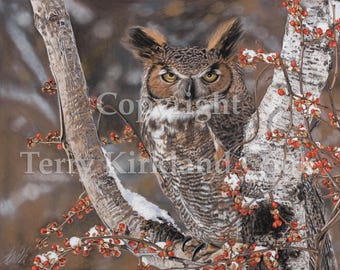 May include: A great horned owl perched on a snow-covered branch with red berries. The owl has brown and white feathers and yellow eyes. The background is a blurred brown and white.