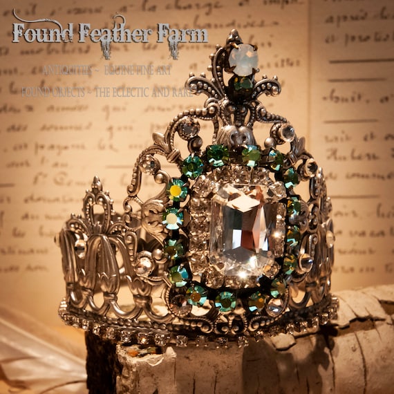 Silver Repousse Metal Shell Crown With a Large Clear Rhinestone Surrounded by Turquoise Rainbow Rhinestones