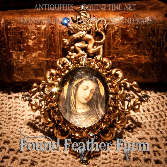 Handmade Magnet with a Jeweled Embellished Glass Cabochon on Brass and Featuring An Image of Mary with a Regal Brass Lion Crest