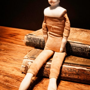 Large Antique German Doll with Porcelain Head, Arms and Legs and Dressed in Raw Muslin