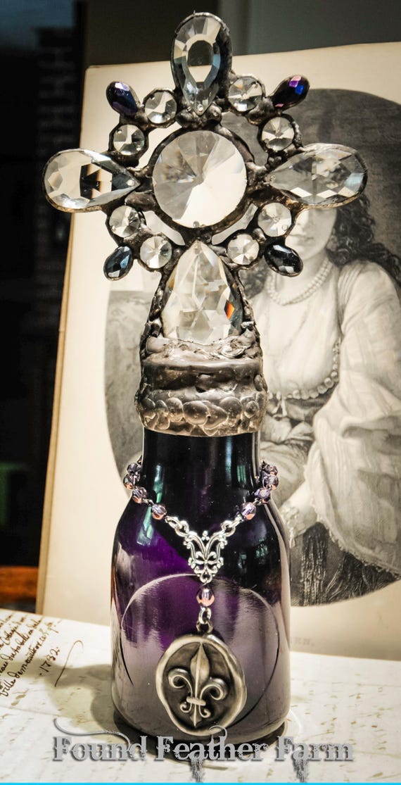 Antique Dark Cobalt Glass Milk Cross Bottle with a Pewter Fleur De Lis Pendant held by a Glass Beaded Chain