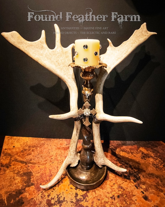 Vintage English Fallow Antlers Adorn a Tall Bronze Candleholder With a Brass Cross and Vintage Brooch