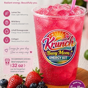 May include: A clear plastic cup filled with a bright pink iced beverage and a pink straw. The cup features a Krunch Busy Mom Energy Kit logo, text listing ingredients like Lemon Tea and Collagen, and a 32 oz serving recommendation. Fresh strawberries and blackberries are arranged at the base.