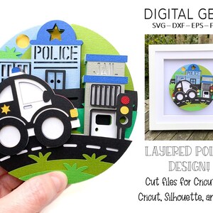 May include: Layered papercraft design of a police car driving past a police station and jail. The design is in a circle and includes a traffic light, bushes, and a road. The design is for use with a Cricut cutting machine.
