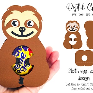 May include: A brown sloth-shaped egg holder with a smiling face and a cutout to hold an egg. The design includes SVG, DXF, and EPS files. Text on the image reads "Digital Gems" and "Sloth egg holder design."