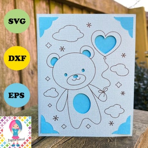 May include: A light blue card featuring a cut-out teddy bear holding a heart-shaped balloon. The card has a brown outline of the bear, clouds, and stars. Blue decorative accents are in the corners. The image also includes the text "SVG", "DXF", and "EPS".