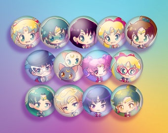 May include: A collection of 12 round, glossy buttons featuring colorful anime-style illustrations of various characters. Each button has a unique design with vibrant colors and detailed facial expressions. The buttons are arranged in three rows of four.
