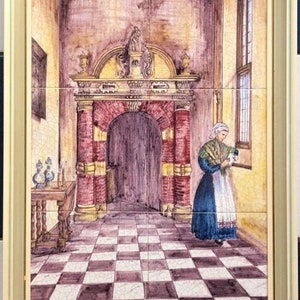 May include: A framed tile painting depicting a woman in a blue dress and white apron standing in a room with a checkered floor. The room has a large arched doorway with red brick columns and a wooden door. The woman is holding a fan in her hand.