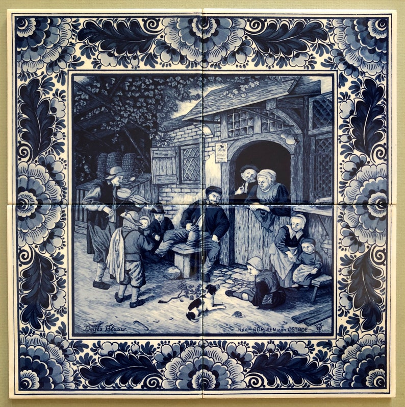 May include: A blue and white Delft tile depicting a scene of people gathered outside a building. The tile has a decorative border of blue and white flowers. The text "De Witte Bloem" and "Maasdriessen van Ostade" are visible on the tile.