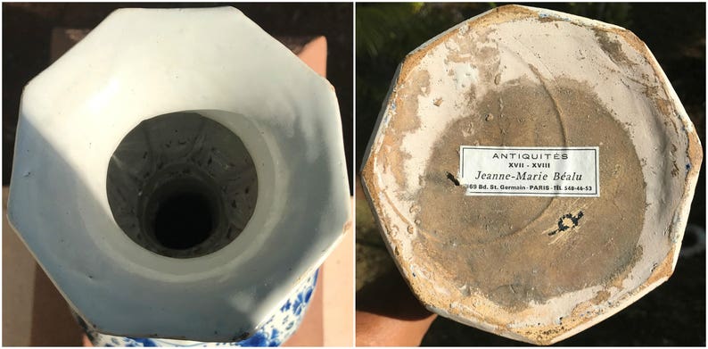 May include: An antique, octagonal porcelain vase with a white and blue floral pattern. The interior is white, and the base features a label with text. This vintage vase is a testament to craftsmanship and historical design.