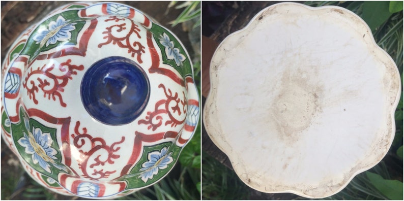 May include: A two-part ceramic serving dish with a floral and scroll design. The top bowl has a white base with red, green, and blue accents. The bottom is a white, scalloped dish.