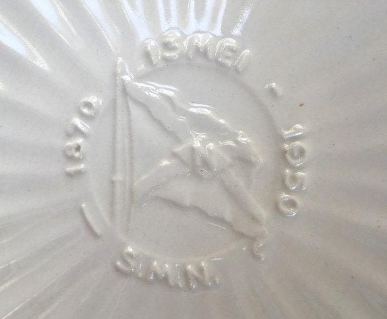 May include: White ceramic plate with a raised design of a ship and the text "ISRAEL 1950 - OBI - SIMIN".