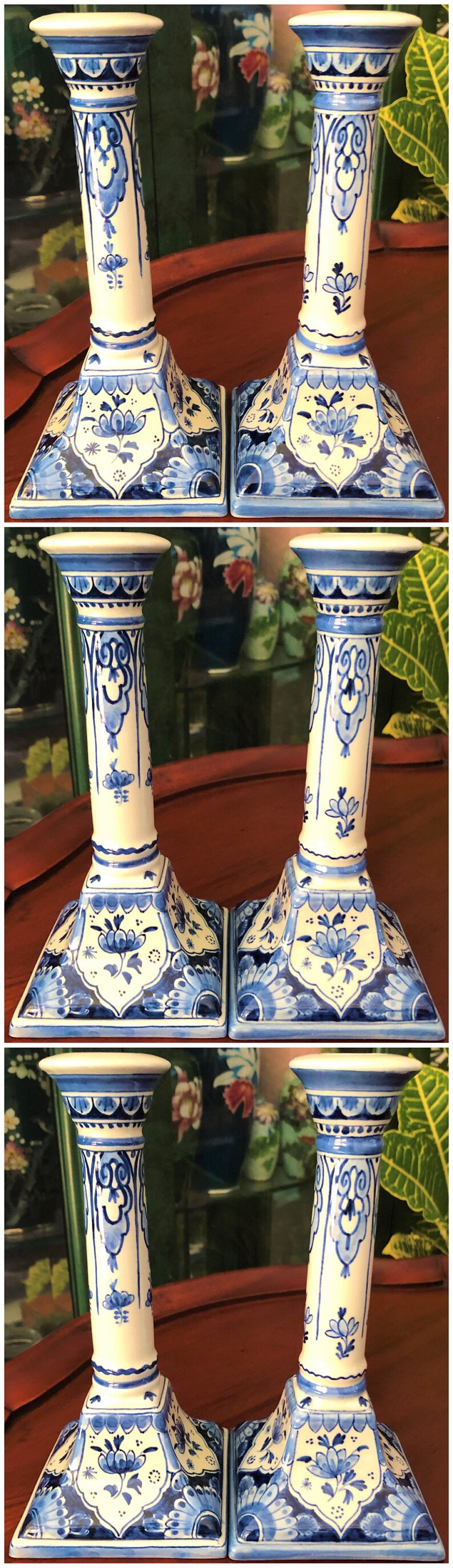 May include: A pair of blue and white ceramic candlestick holders with intricate floral designs. The candlesticks have a square base and a tall, cylindrical column.