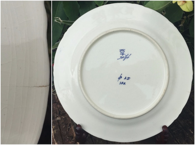 May include: A white ceramic plate with blue markings on the bottom. The markings include the number "25" and the letters "A.Z. 388".