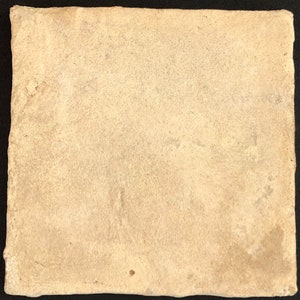 May include: A square, off-white ceramic tile with a textured surface. The tile has a slightly irregular edge and a matte finish. The colour is a warm, neutral tone, suitable for various design applications.