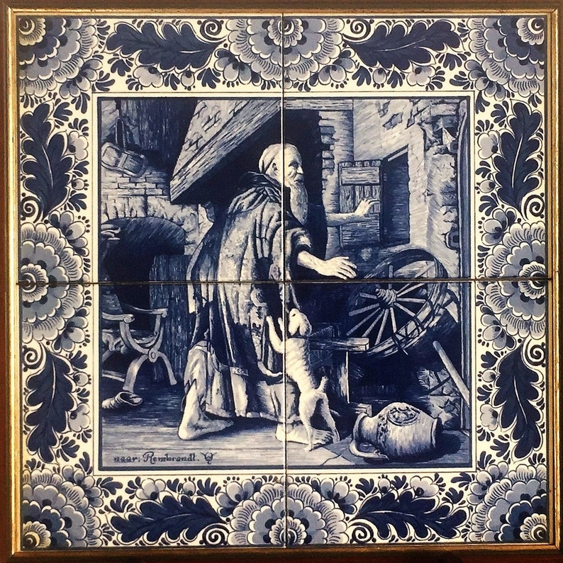 May include: A blue and white Delft tile depicting a man with a beard and a dog in a workshop setting. The tile has a decorative border with floral motifs. The text "naar Rembrandt" is visible at the bottom of the tile.