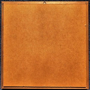 May include: A brown wooden picture frame with a light brown backing.