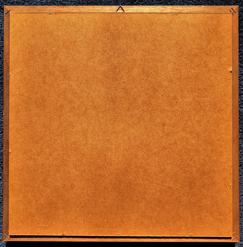 May include: A brown wooden picture frame with a light brown backing.