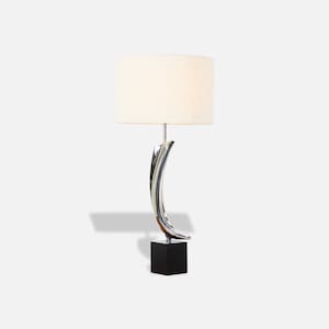 May include: A modern table lamp with a white fabric shade and a chrome base shaped like a curved line. The base is mounted on a black square base.