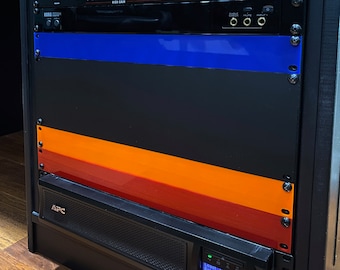 May include: A black rack-mounted audio equipment setup. The rack includes a Furman power conditioner, a guitar preamp labeled "Widowmaker", and other audio components. Colored panels in blue, orange, and red add visual interest.