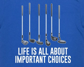 May include: A royal blue t-shirt with a graphic of golf clubs and the text "Life is all about important choices".