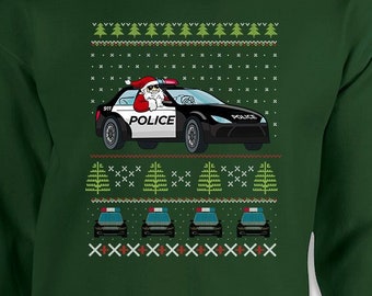 May include: Green sweatshirt with a festive design. The graphic features Santa Claus driving a police car, with the word "POLICE" on the side. Additional police cars and Christmas tree patterns complete the holiday theme.