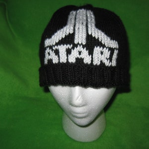 May include: Black knit beanie with a white knit Atari logo.