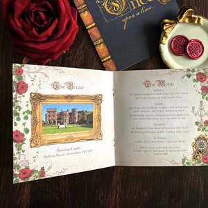 May include: An open wedding invitation with a castle image in a gold frame, surrounded by red roses and decorative flourishes. The menu lists starters, mains, and desserts. A red rose and a decorative plate with wax seals are also visible.