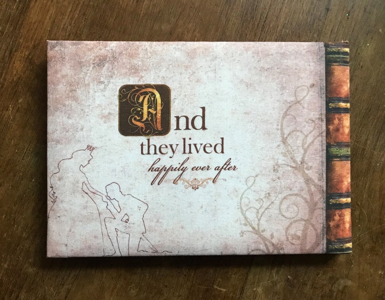 May include: A vintage-style book cover with a decorative floral design and the text "And they lived happily ever after".