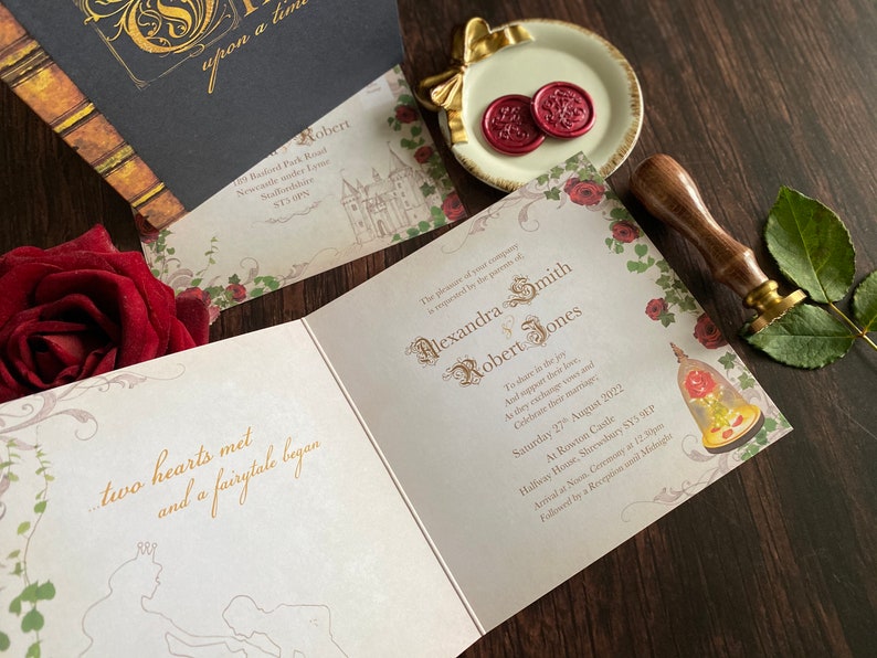 May include: Wedding invitation suite with a fairytale theme. The open invitation features gold script with the names Alexandra Smith and Robert Jones. A red rose and wax seals are also visible.