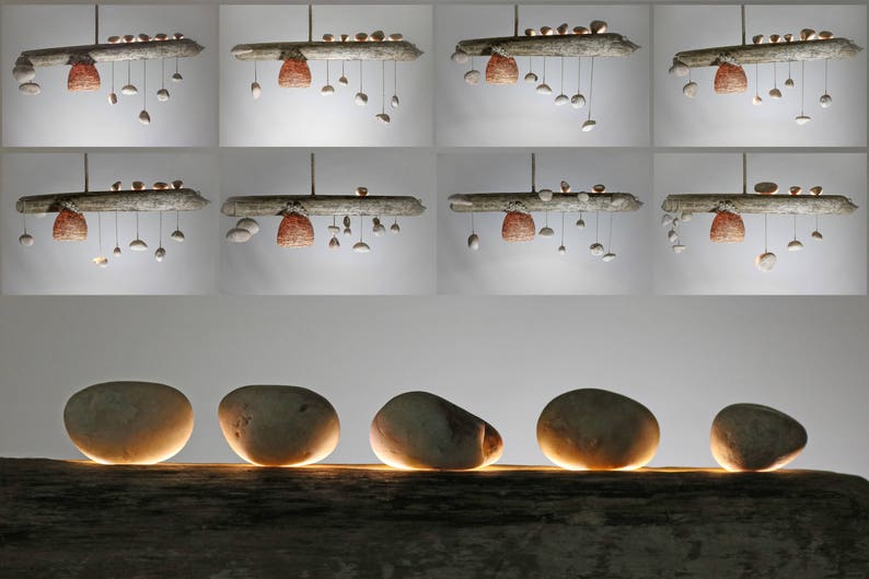 May include: Five smooth, round, light brown stones are arranged in a row on a weathered, light brown wooden surface. The stones are illuminated from below, casting a warm glow.