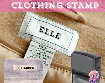 May include: A clothing stamp with the text "CUSTOM NAME CLOTHING STAMP" in white letters. The image shows a clothing label with the name "ELLE" and a smaller label with "S HARPER". A black stamp is in the image.