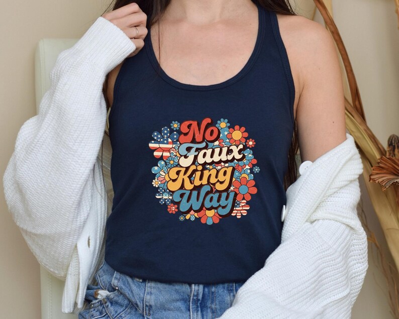May include: Navy blue tank top with the text "No Faux King Way" in a retro floral design. The text is in red, orange, yellow, and blue. The floral design includes red, white, and blue elements.