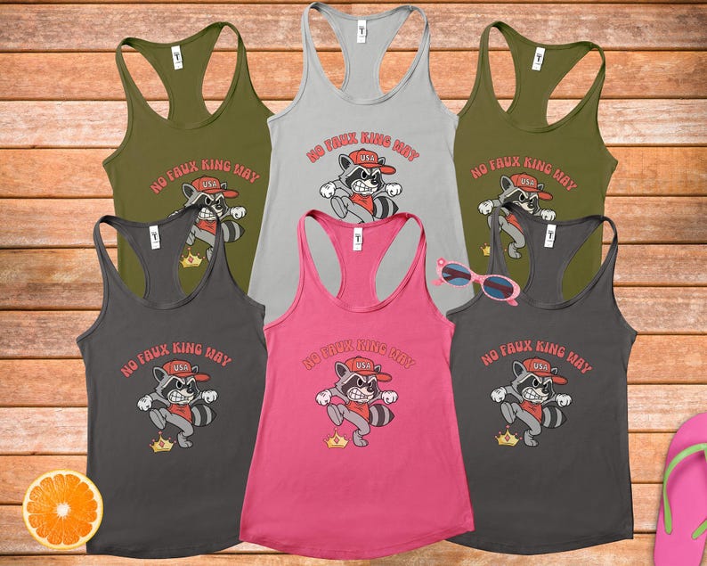 May include: A collection of six racerback tank tops in various colors, including olive green, gray, and pink. Each tank top features a cartoon raccoon graphic with the text "NO FAUX KING WAY" and "USA".