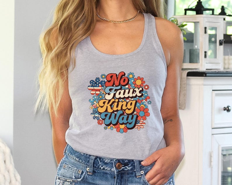 May include: A gray tank top with the text "No Faux King Way" in a retro font, surrounded by a floral design with red, white, blue, orange, and yellow flowers. The tank top is paired with blue denim shorts.