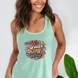 May include: A light green tank top with a retro graphic that reads "No Faux King Way" in a colorful floral design. The text is in a mix of fonts and colors, with a vintage aesthetic.