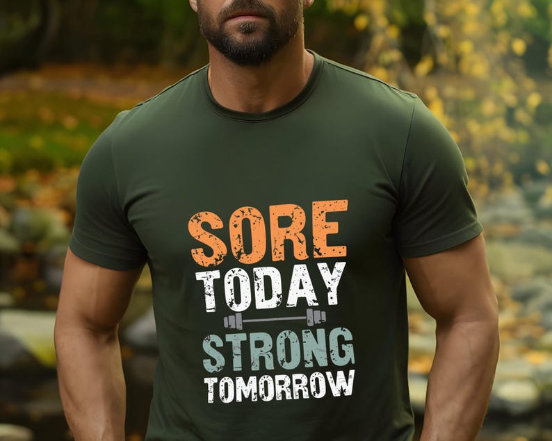 May include: A green t-shirt with the text "Sore Today Strong Tomorrow" in white and orange lettering. A small barbell graphic is above the word "Strong".