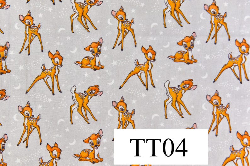 May include: A white fabric with a repeating pattern of brown deer silhouettes. The deer are in various poses, including standing, running, and jumping. The fabric has a subtle sparkle effect, giving it a whimsical feel.