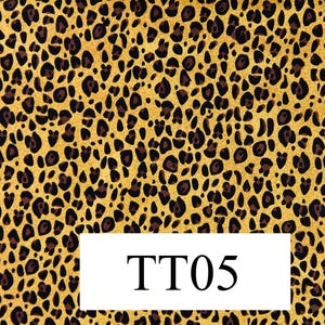 May include: A yellow and brown fabric with a leopard print pattern. The fabric has the text "TT05" printed on it.