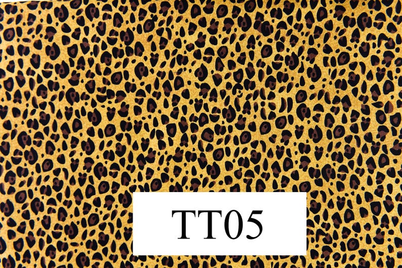 May include: A yellow and brown fabric with a leopard print pattern. The fabric has the text "TT05" printed on it.