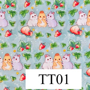 May include: A blue and white fabric with a repeating pattern of three bunnies and strawberries. The bunnies are white, orange, and purple. The strawberries are red. The text "TT01" is in the centre of the image.