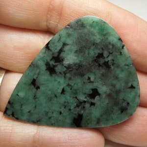 Peut inclure: Un cabochon de pierre pr&eacute;cieuse vert et noir avec un motif unique et mouchet&eacute;. Le cabochon est en forme de larme et a une surface lisse et polie.