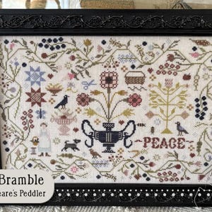 May include: Framed cross-stitch sampler titled "Spring Bramble" by Shakespeare's Peddler. The design features floral and fauna motifs, including birds, flowers, and the word "PEACE". The frame is black with ornate detailing.