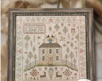 May include: A cross-stitch pattern depicting a brick house with a stepped terrace, surrounded by trees and flowers. The text "For genuine happiness we need not roam- tis doubtless found with little & at home." is stitched above the house. The text "A brick house on a stepped-terrace" is below the house. The pattern is framed in a brown wooden frame.